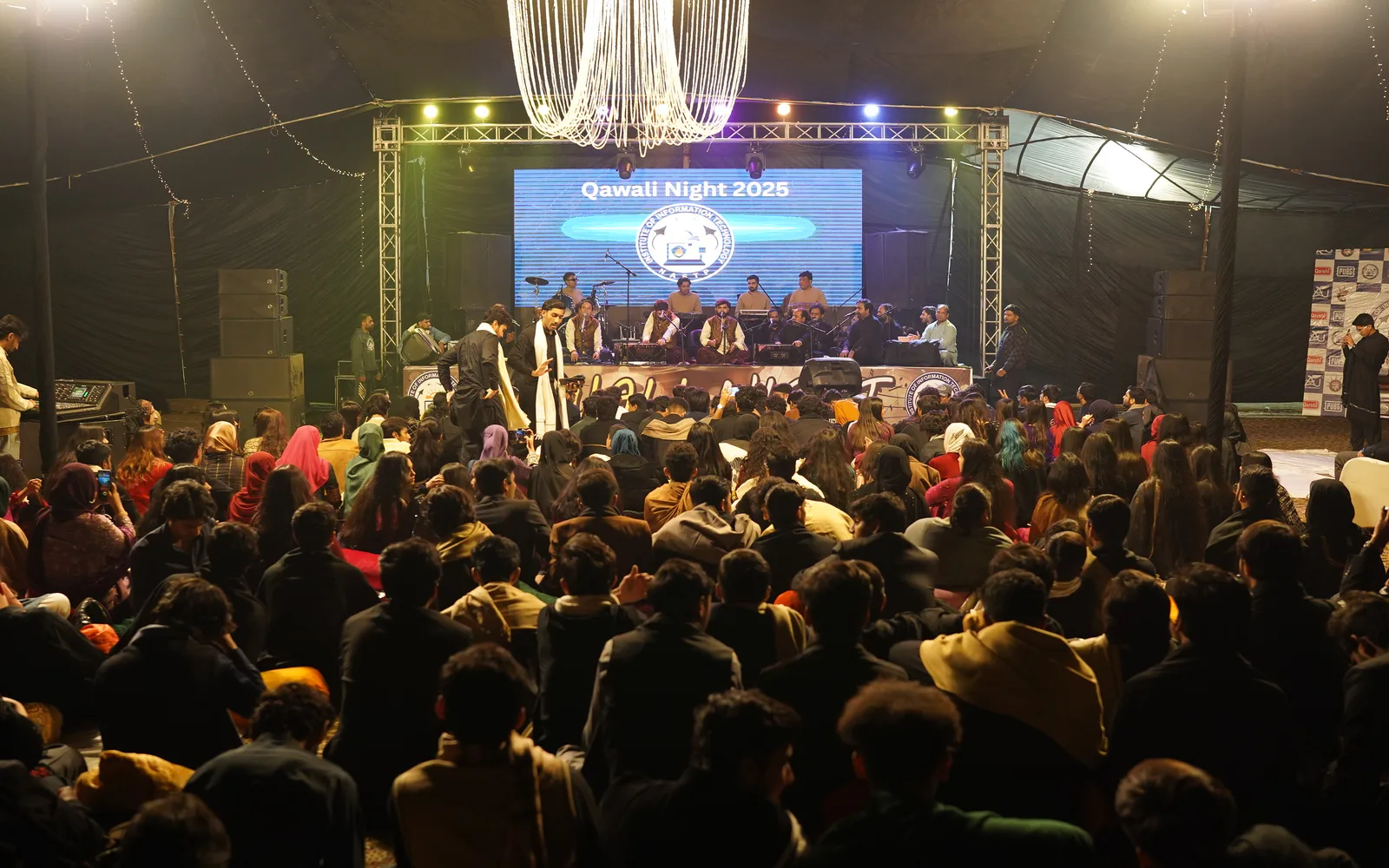 Students watching a campus stage performance.